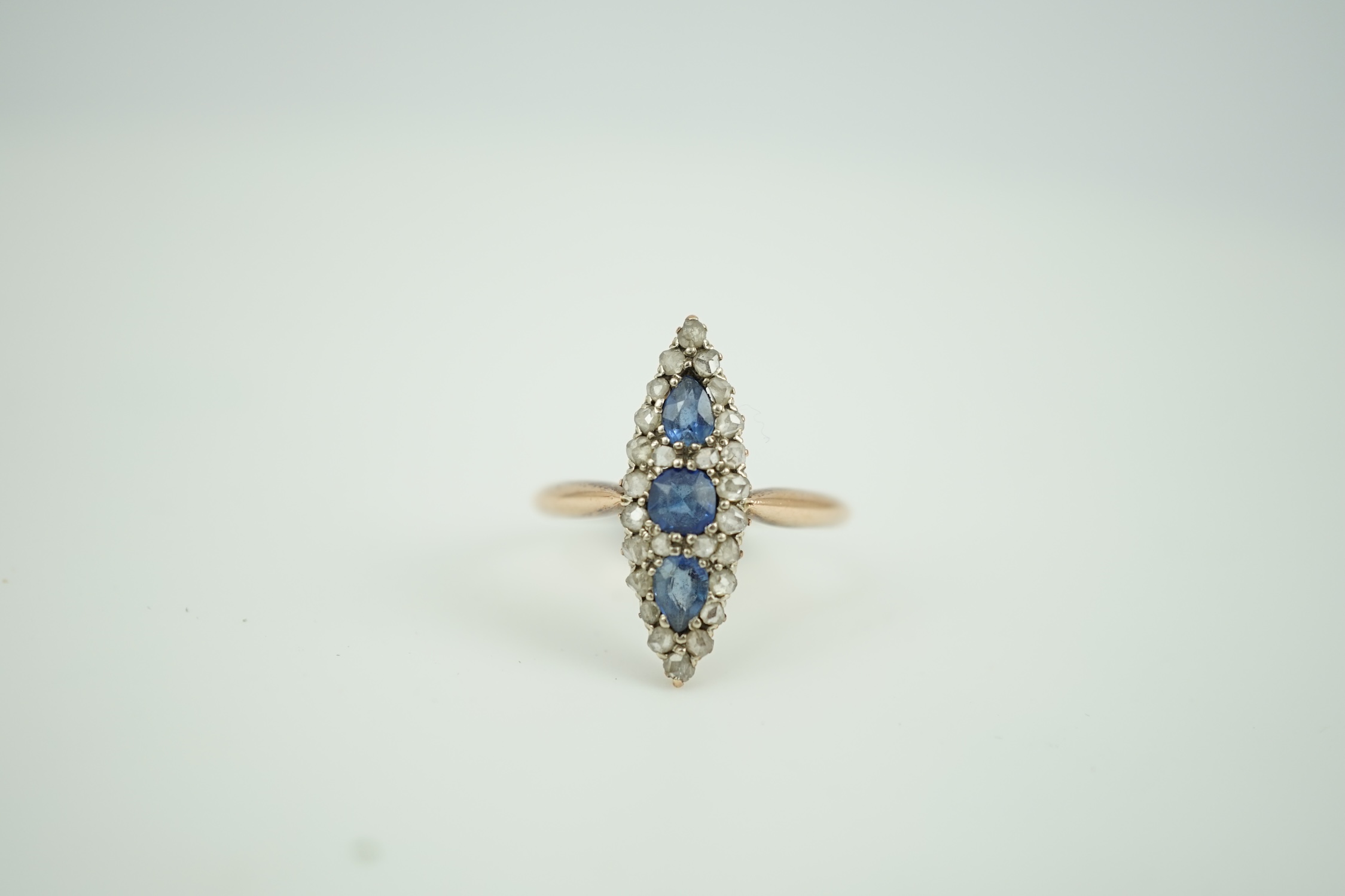 An early 20th century yellow metal, sapphire and rose cut diamond set marquise cluster ring, size Q, gross weight 2.8 grams.